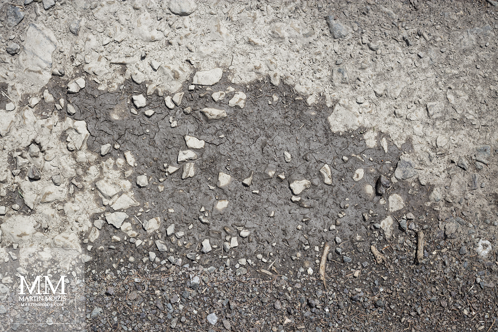 A drying puddle on a dirt road. A photograph created with Canon EF 50 mm 1:1.8 STM lens.