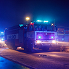 A fire truck Tatra in action, white and blue lights, smoke.