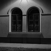 Illuminated windows at night. Title photograph of gallery Diaries XXIV.