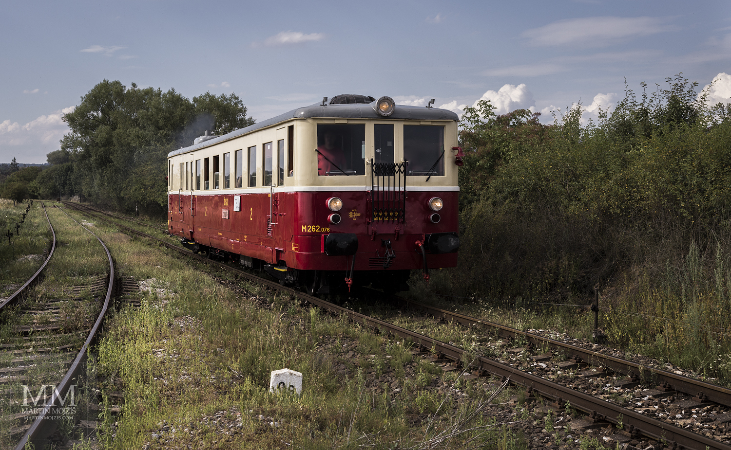 Large format, fine art photograph of small yellow and red train. Martin Mojzis.