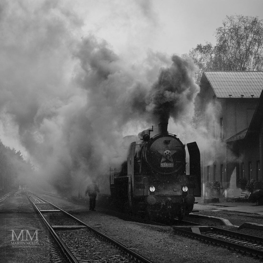 Large format, fine art black and white photograph of steam locomotive in head of passenger train. Martin Mojzis.