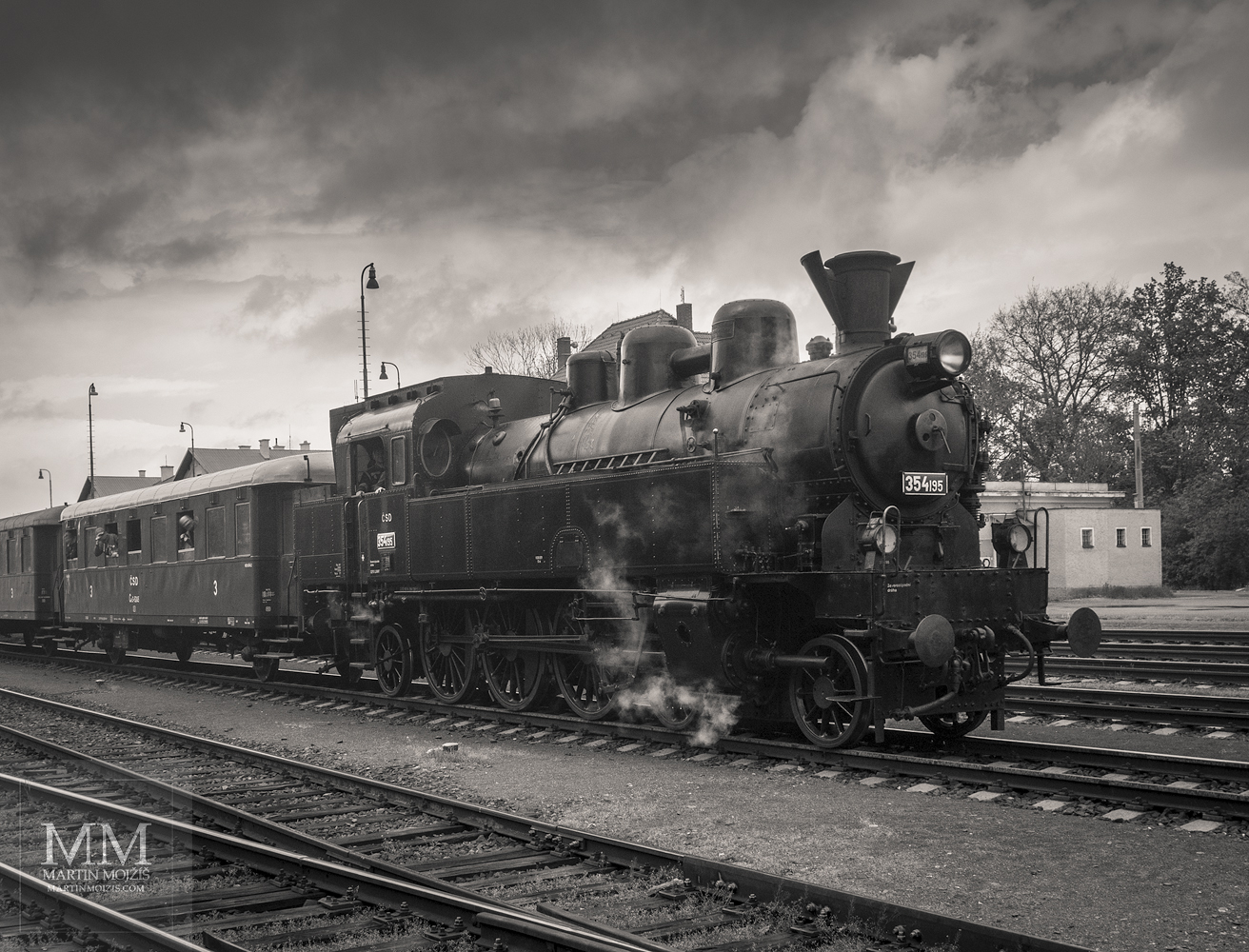Umělecká černobílá tónovaná fotografie parní lokomotivy 354 195 v čele osobního vlaku. Martin Mojžíš.