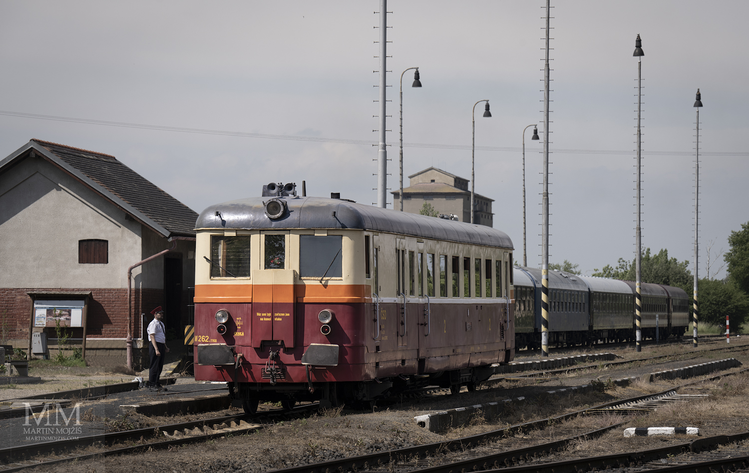 A dispatcher talks to a engine driver of a engine railway car M 262.1168, standing at the railway station. Fine art photograph UNDER RIP HILL LITTLE RAILCAR II, photographed by Martin Mojzis.