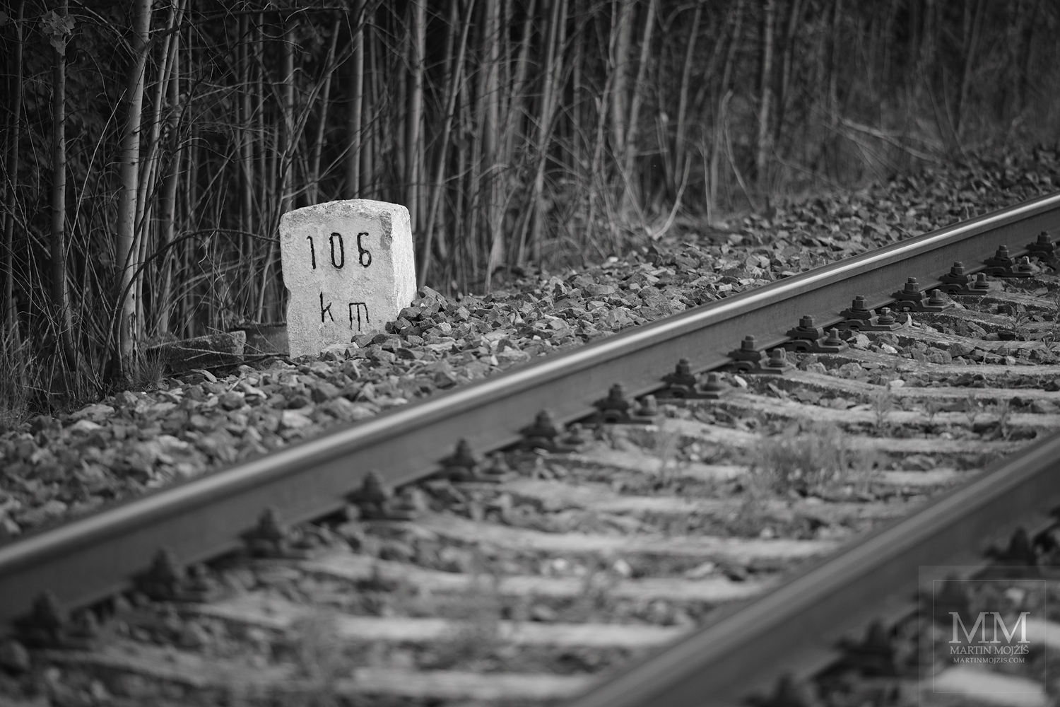 Hectometer stone by the dormitories (rails). Fine art black and white photograph AWAITING OF SUMMER TRAVELS, photographed by Martin Mojzis.