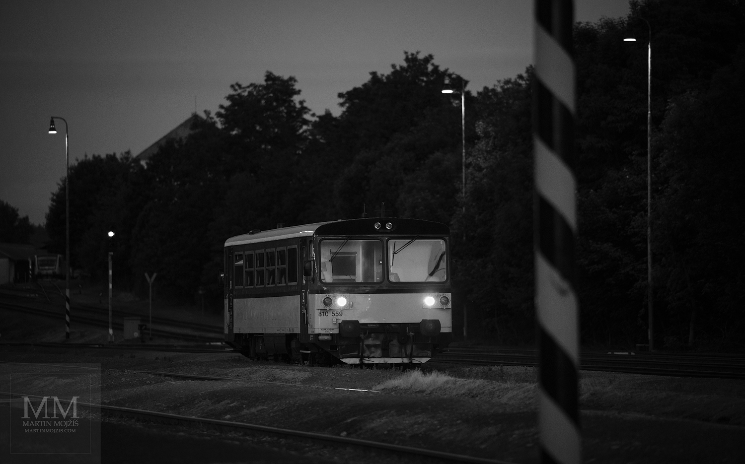 A tiny engine train and a evening railway station. Fine art black and white photograph EVENING TINY ENGINE TRAIN I., photographed by Martin Mojzis.