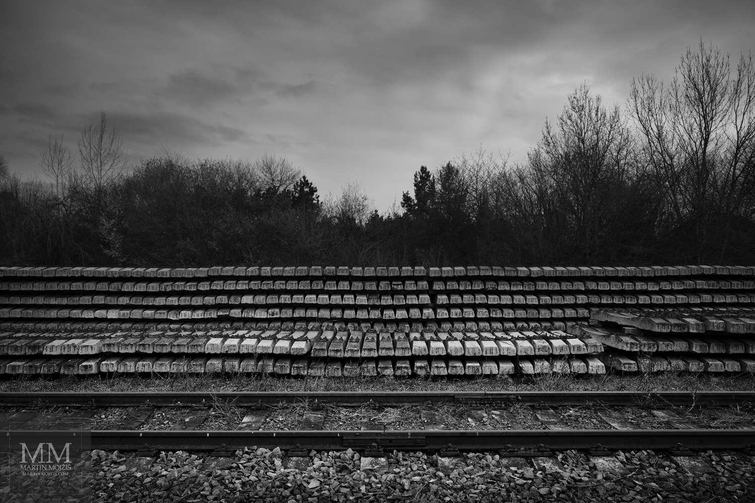 Many railroad ties (sleepers) next to the tracks. Fine art black and white photograph MANY TIES, photographed by Martin Mojzis.