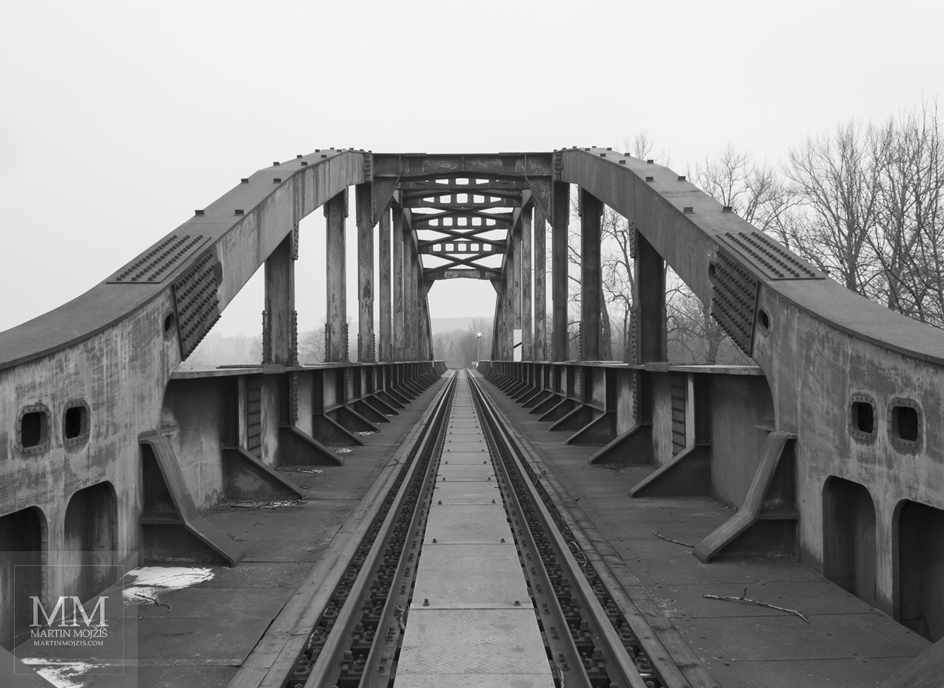 Arches of the construction of the steel railway bridge. Fine Art black and white photograph of Martin Mojzis with the title TO THE HORIZON.
