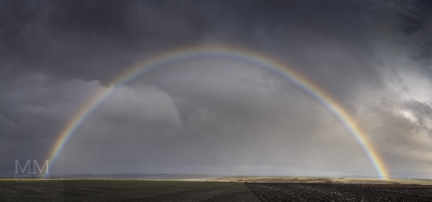 Panoramic photograph of the rainbow above the landscape. Martin Mojzis.