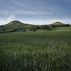 Large format fine art photograph of landscape with small hills.