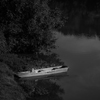 Large format fine art black and white photograph of boat on the river.
