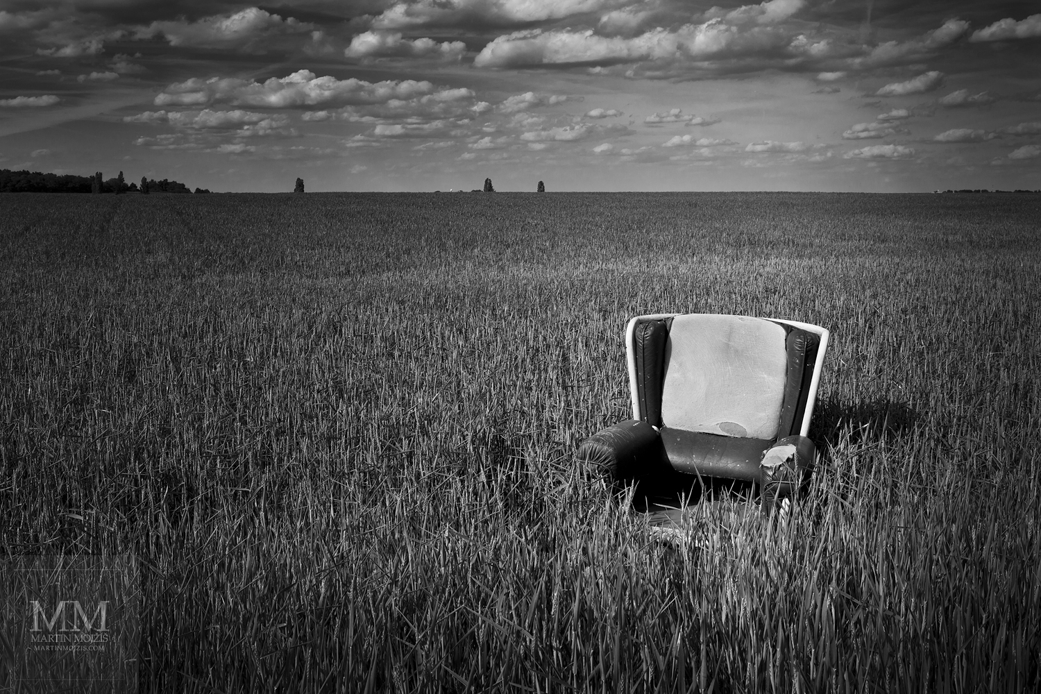 An armchair in a cereal field. Fine Art black and white photograph by Martin Mojzis with the title WELCOME TO MY HOUSE IV.
