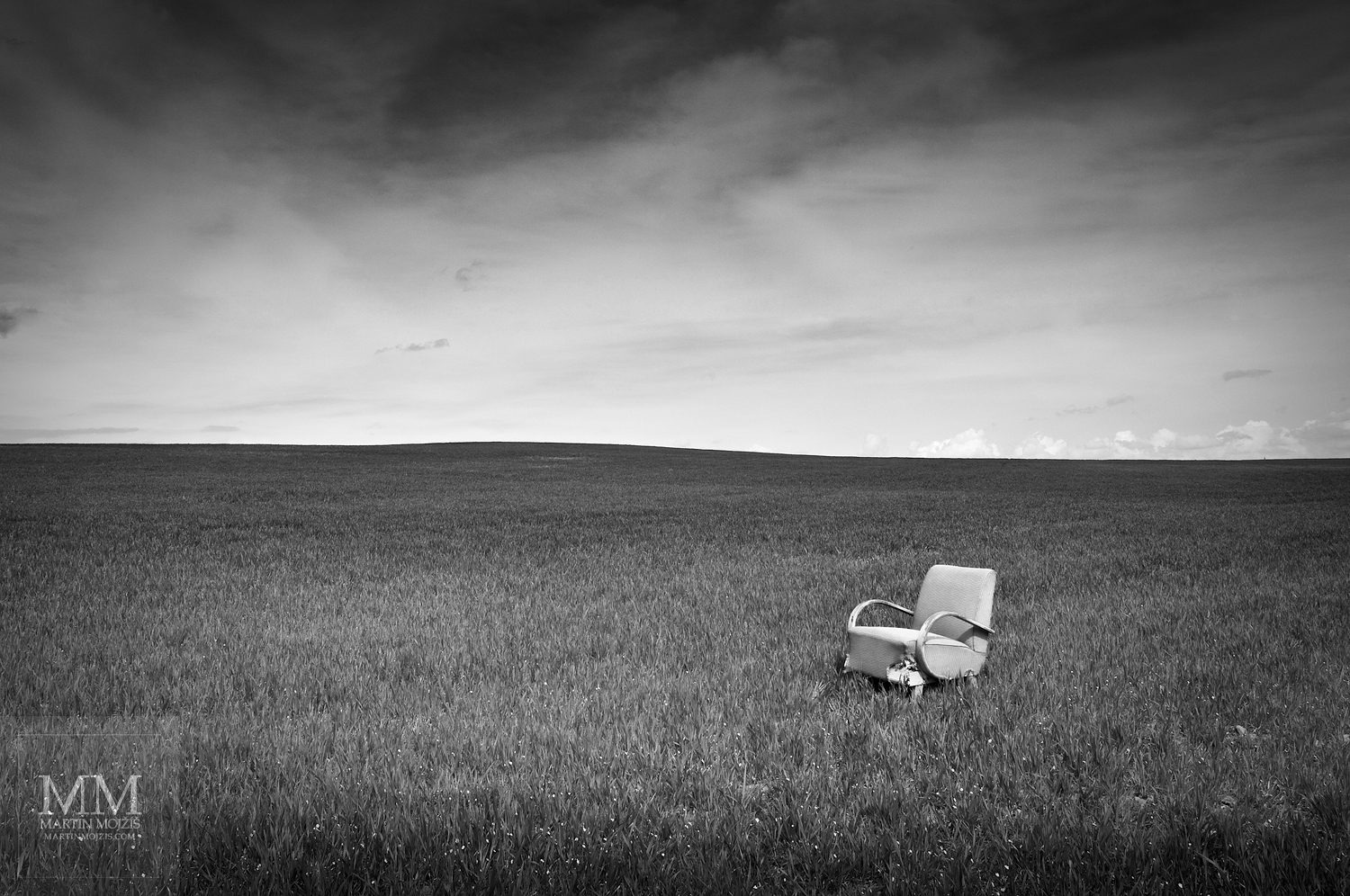 An armchair in a cereal field. Fine Art black and white photograph by Martin Mojzis with the title WELCOME TO MY HOUSE II.